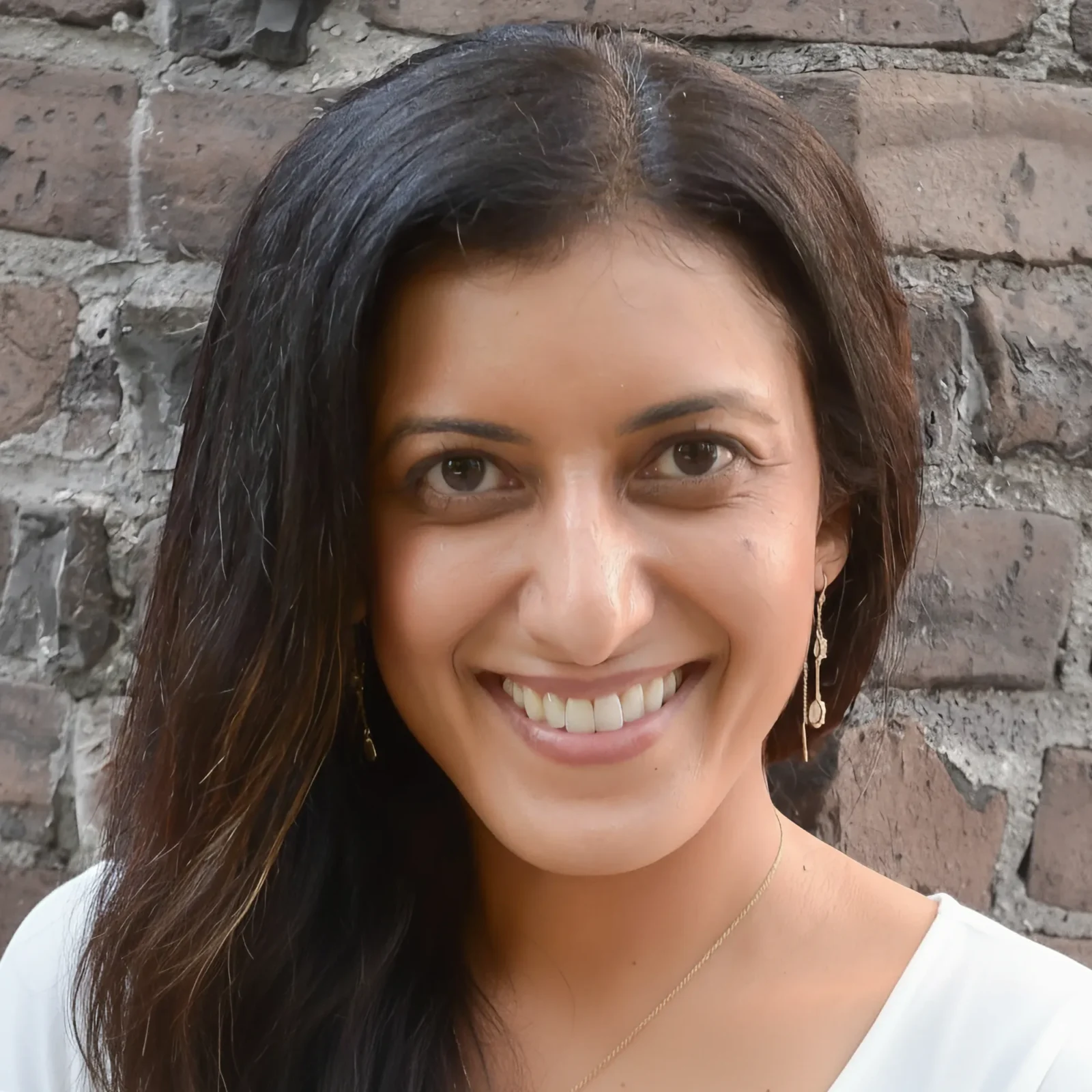 Nandini Narula – Founder of Sertus Partners smiling at the camera wearing a white shirt.